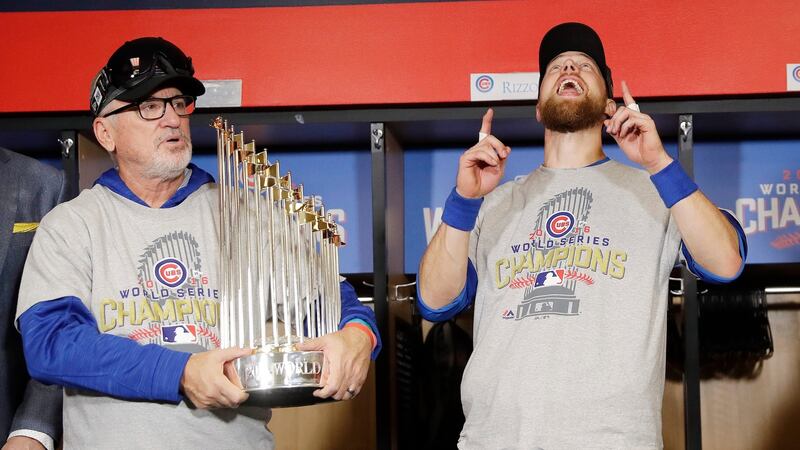 Chicago Cubs manager Joe Maddon (L) holds the Commissioner’s trophy as he celebrates with Ben Zobrist (R) after the Cubs won the World Series over the Cleveland Indians. Photograph: David J Phillip/EPA