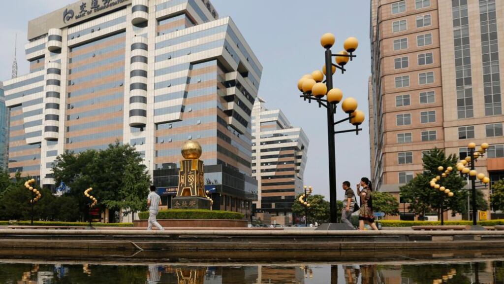 Chinese people walk down Financial Street in Beijing yesterday. Market players are holding their breath to see if yesterday’s market rebound was a “dead cat bounce” or a signal the bull run can continue, albeit at a less frantic pace. Photograph: EPA