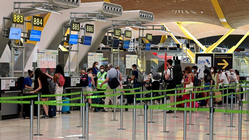 Travelers stand in a queue in front of the baggage drop-off desks at Terminal 4 of Adolfo Suarez-Madrid Barajas international airport, in Madrid, on Sunday. A surprise 14-day quarantine for all UK residents arriving from Spain was imposed at midnight. Photograph: EPA