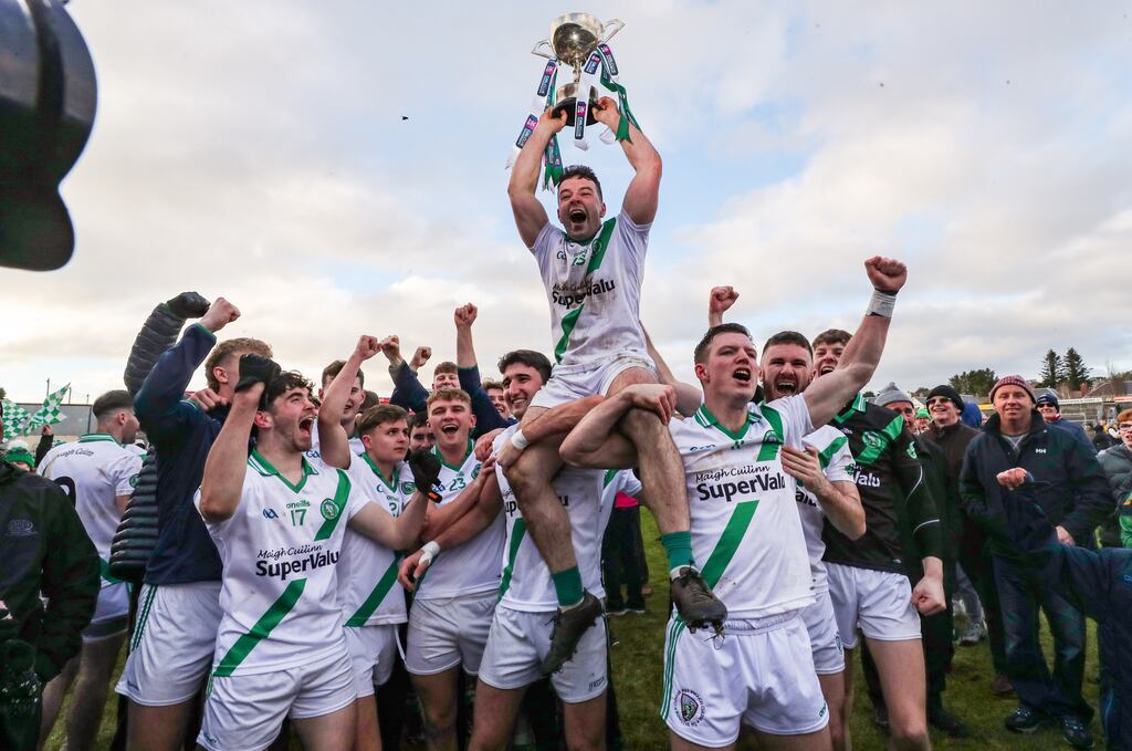 Dessie Conneely and his Moycullen teammates celebrate with the Shane McGettigan Cup after the victory over Tourlestrane at Pearse Stadium. Photograph: Bryan Keane