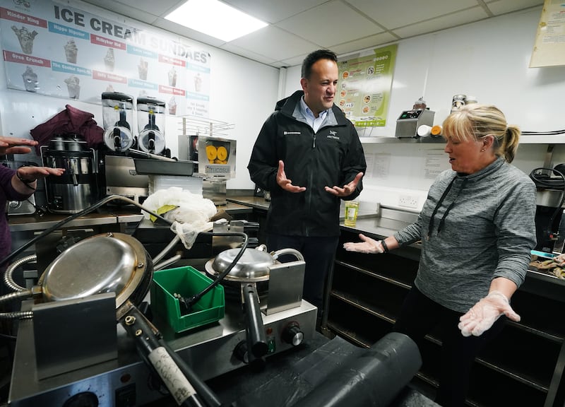 Taoiseach Leo Varadkar speaks with Frances Steele on Thursday as she helps clean up a business belonging to a friend on Main street in Midleton. Photograph: Brian Lawless/PA Wire