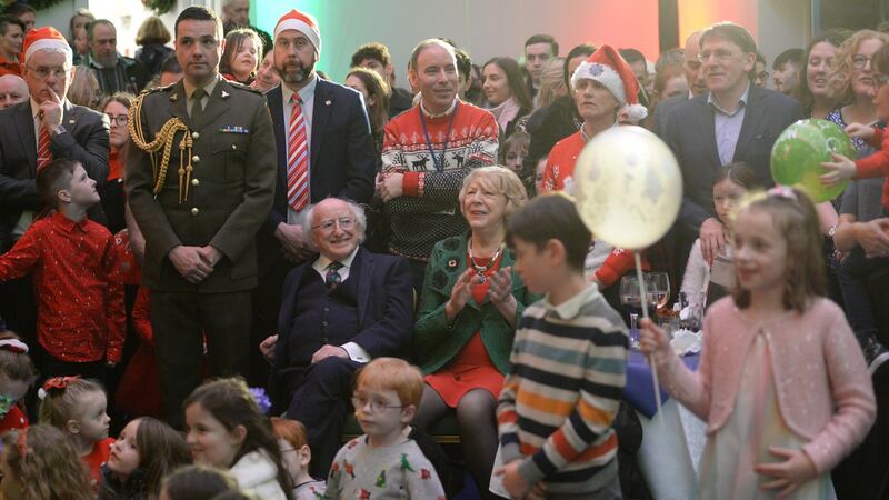 President Michael D Higgins and his wife Sabina at the centre of the crowd at Áras an Uachtaráin amid the tree-lighting ceremony ahead of the Christmas season. Photograph: Dara Mac Dónaill