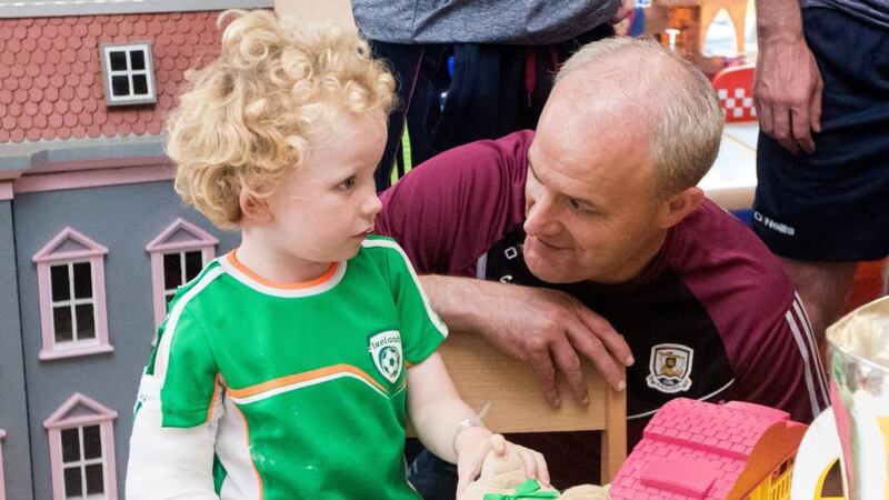 All-Ireland champions: Galway manager Micheál Donoghue with James Dylan at Our Lady’s Children’s Hospital, in Crumlin. Photograph: Oisin Keniry/Inpho