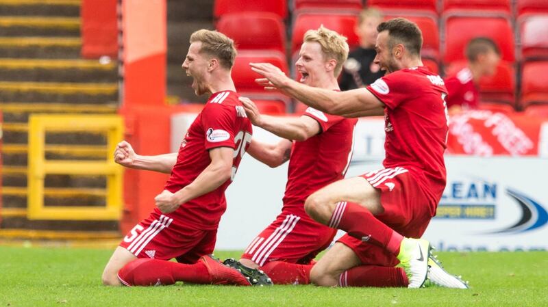 Aberdeen’s Bruce Anderson (left) celebrates scoring his side’s first goal with team-mates during the Scottish Premiership match against Rangers at Pittodrie. Photograph: Jeff Holmes/PA Wire