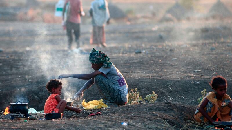 Ethiopian migrants who fled intense fighting in their homeland of Tigray cook a meal in the border reception centre of Hamdiyet, in the eastern Sudanese state of Kasala, on November 14th. Photograph: Ebrahim Hamid/AFP via Getty Images
