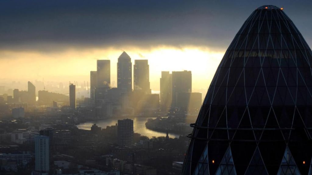 The ‘Gherkin’ and Canary Wharf at sunrise in the City of London. Photograph: Stefan Rousseau/PA Wire