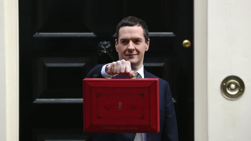 British chancellor of the exchequer George Osborne holds his ministerial red box up to the media as he leaves 11 Downing Street on Wednesday. The chancellor was presenting his fifth budget to MPs, the last before the general election on May 7th. Photograph: Dan Kitwood/Getty Images
