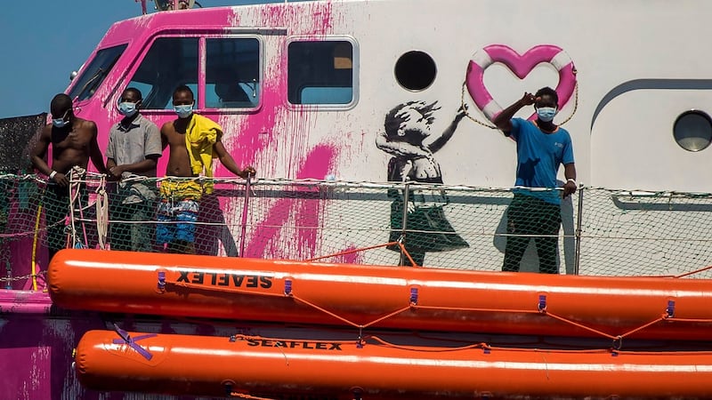 A boy waves to the crew of the Astral rescue vessel from the deck of the Louise Michel rescue vessel, a French patrol boat currently manned by activists and funded by the renowned artist Banksy in the central Mediterranean sea, at 50 miles south from Lampedusa on Friday. Photograph: Santi Palacios/AP