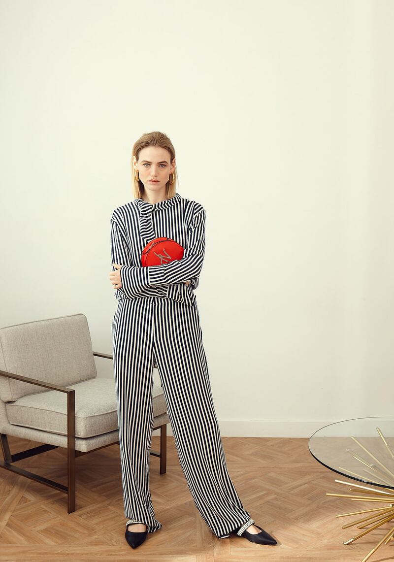 Stripe top €199m trousers €199 both Hugo Boss, crossbody bag €245 Karl Lagerfeld, shoes €145 Kurt Geiger, earrings €198 Thomas Sabo, West Elm metal frame chair €799, corner sofa €2699