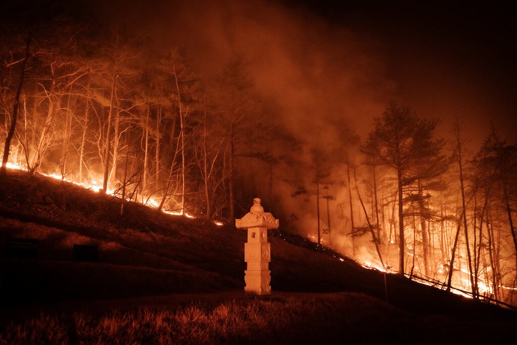 South Korea: A wildfire is seen next to a stone lantern of a family tomb in Andong on March 26th. Photograph: Getty Images