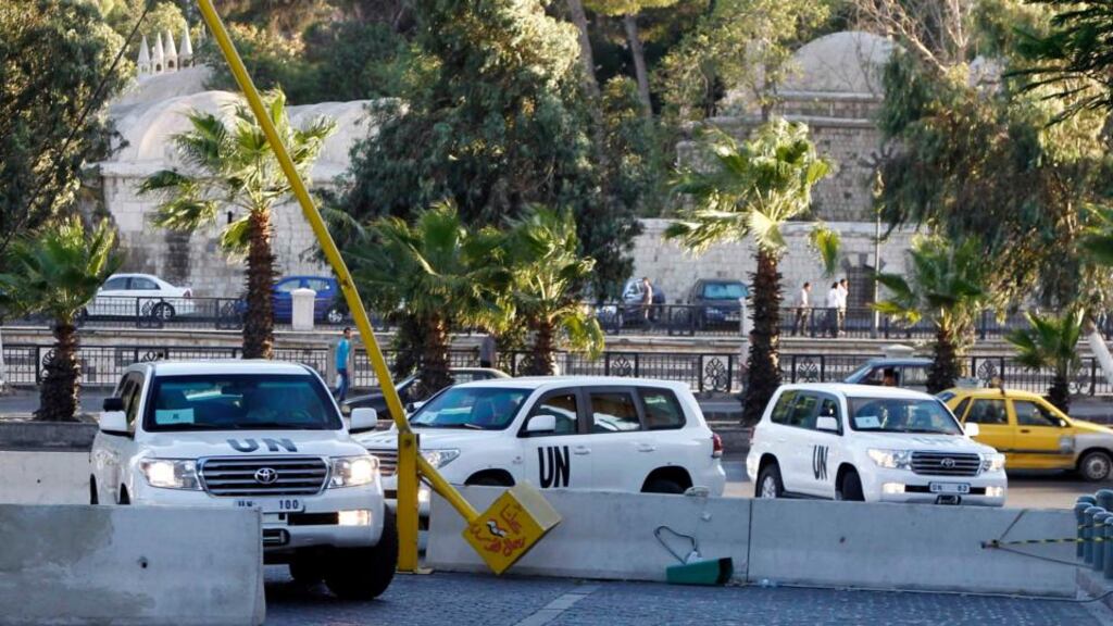 UN vehicles transporting a team of experts from the Organisation for the Prohibition of Chemical Weapons are pictured as they return to their hotel in Damascus today. Photograph: Khaled al-Hariri/Reuters
