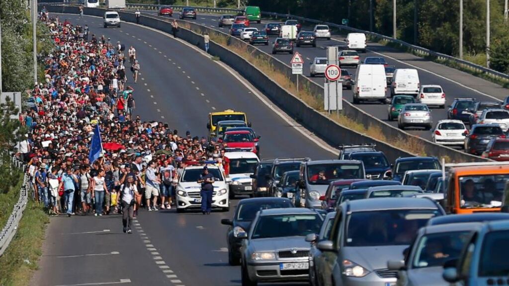 People escaping war and poverty march along the motorway out of Budapest. Photograph: Laszlo Balogh/Reuters