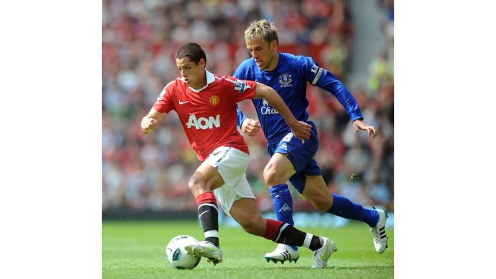 Goalscorer Javier Hernandez of Manchester United skips past Phil Neville of Everton during their Barclays Premier League match between at Old Trafford. - (Photograph: Shaun Botterill/Getty Images)