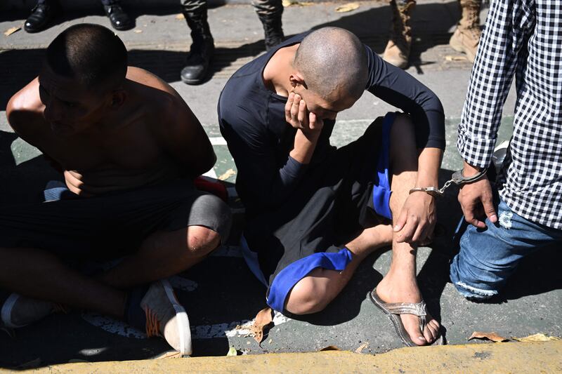 Alleged members of the Calle 18 gang and drug dealers captured by soldiers and police in the Tutunichapa community in San Salvador, El Salvador, in December 2022. Photograph: Marvin Recinos/AFP/Getty