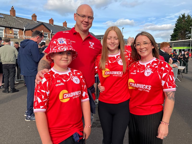 Shelbourne FC fans Richie and Emma Deasy from Blanchardstown with their children, pictured at the entrance to Windsor Park. Photograph: Seanín Graham