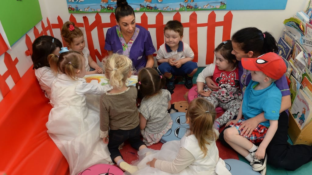 Good outcome: Sinead Mulhall reading with Marie Byrne, (right) to children as part of Chatter Matters at the Larkin Childcare Facility, Ballybough Preschool, Ballybough, Dublin. May 2014. Photograph; Dara Mac Donaill.