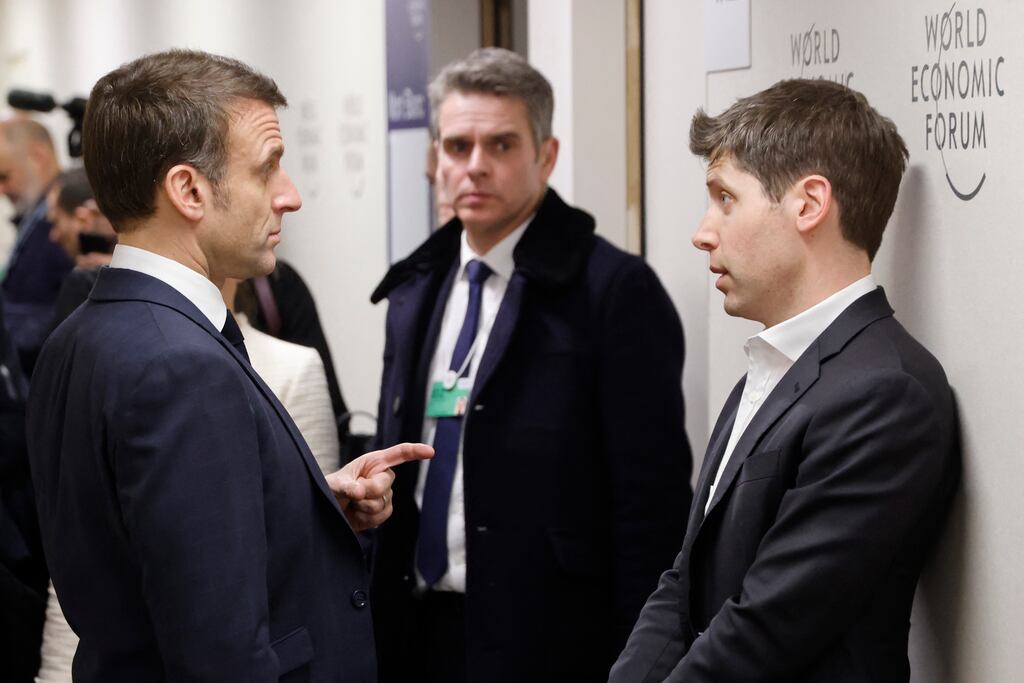 French president Emmanuel Macron (left) speaks with chief executive of OpenAI Sam Altman on the sidelines of the World Economic Forum in Davos. Artificial intelligence was a key theme of the summit. Photograph: Ludovic Marin/AFP via Getty Images