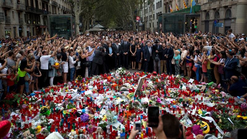 Spain’s King Felipe stands with Queen Letizia and Catalonia regional President Carles Puigdemont at a memorial tribute of flowers, messages and candles to the van attack victims in Las Ramblas promenade, Barcelona. Photograph: AP/Emilio Morenatti