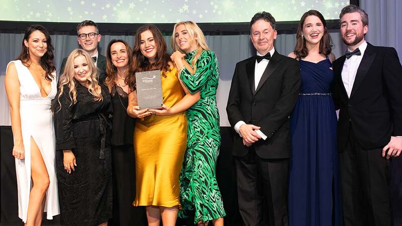 Gerard O'Neill, Chairman, Amárach Research, presents the Sponsorship of the Year award to the Just Eat & Virgin Media Team.