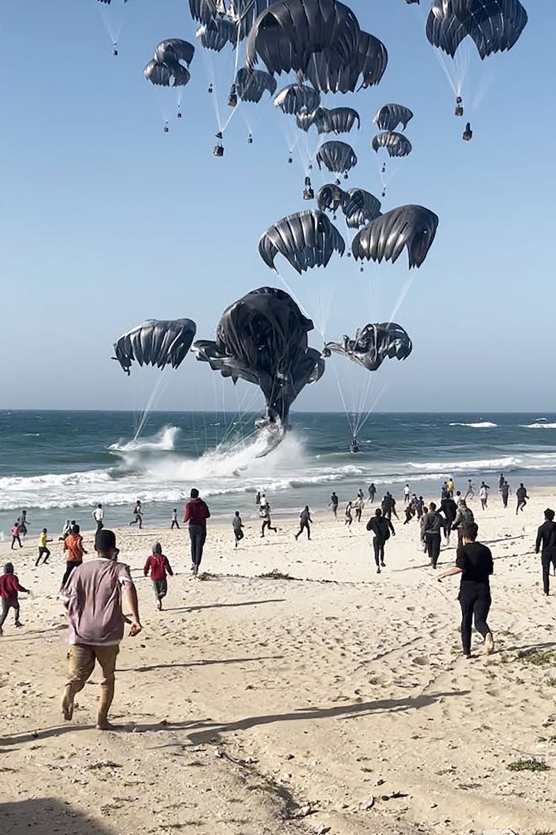 Palestinians run towards parachutes attached to food parcels, air-dropped from US aircrafts on a beach in the Gaza Strip on March 2nd. Photograph: Aline Manoukian/AFP via Getty