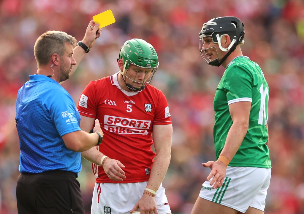 Referee Thomas Walsh shows yellow cards to Cork’s Cormac O’Brien and Limerick's Gearoid Hegarty. Photograph: James Crombie/Inpho