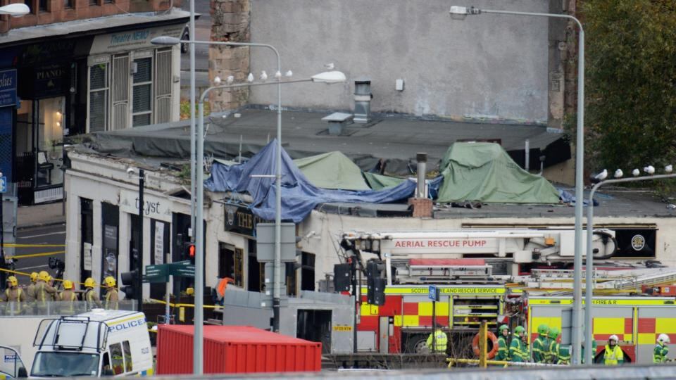 Rescue workers attend the scene at a pub on Stockwell Street where a police helicopter crashed on the banks of the River Clyde. Photograph: Jeff J Mitchell/Getty Images