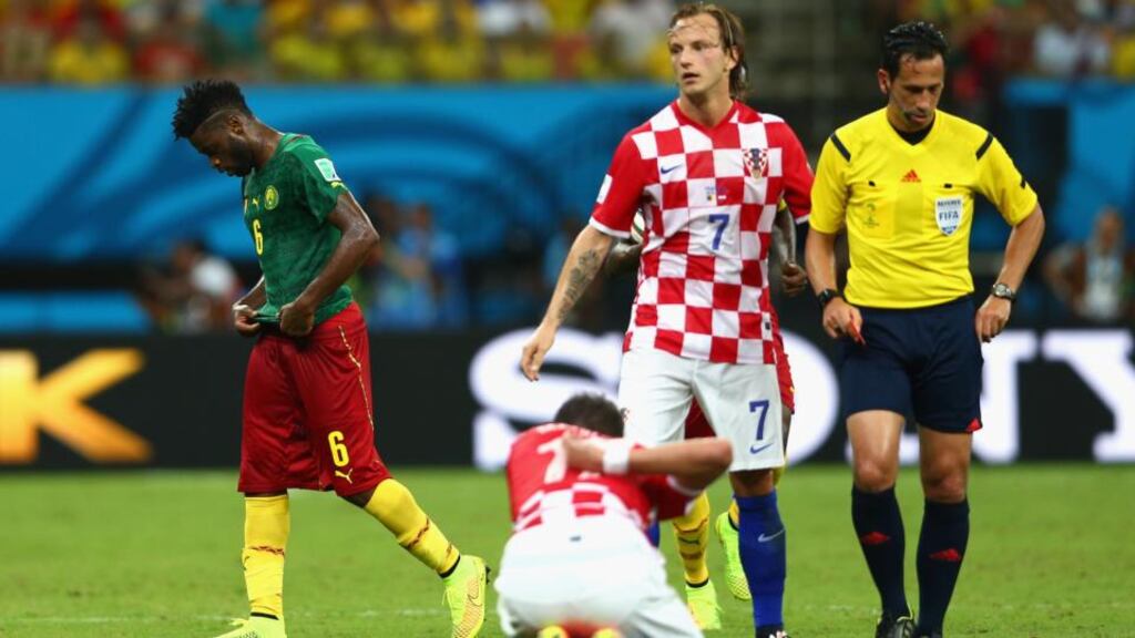 Alex Song of Cameroon walks off the field after receiving a red card for elbowing Mario Mandzukic in the back during the World Cup Group A game at Arena Amazonia in Manaus. Photograph: Clive Brunskill/Getty Images