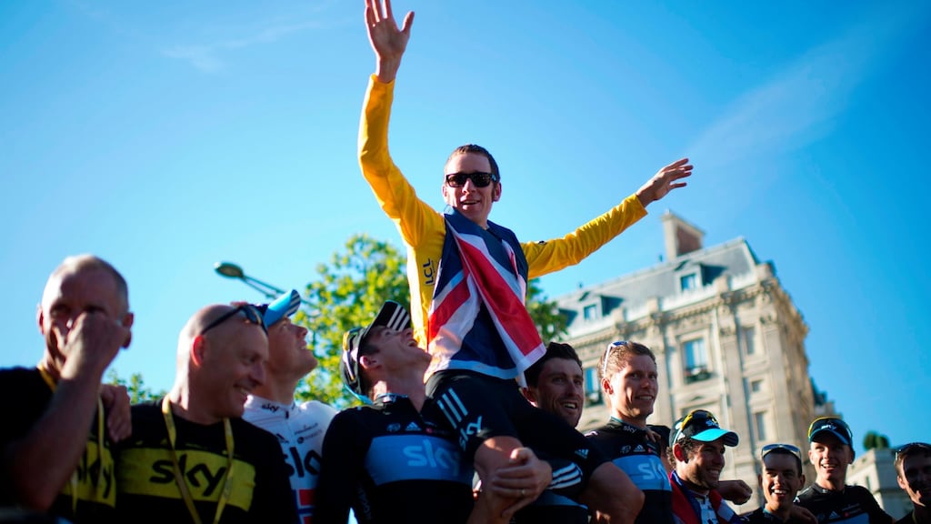 Tour de France 2012 winner Bradley Wiggins celebrates with teammates during a parade on the Champs-Elysees. Floyd Landis has said Wiggins should be stripped of the title. Photo: Jeff Pachoud/Getty Images