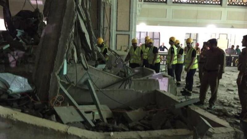 Civil Defence personnel inspect the damage at the Grand Mosque in Mecca. Photograph: Saudi Arabia Civil Defence