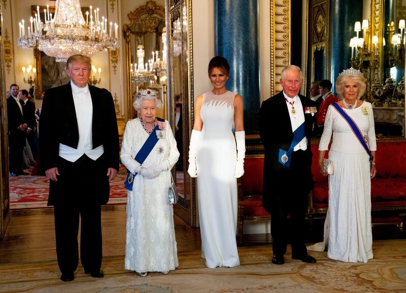 State banquet: her hair swept up, Melania Trump wore a Dior haute-couture white column dress with elbow-length white gloves for the state banquet hosted by Queen Elizabeth. Photograph: Doug Mills/New York Times