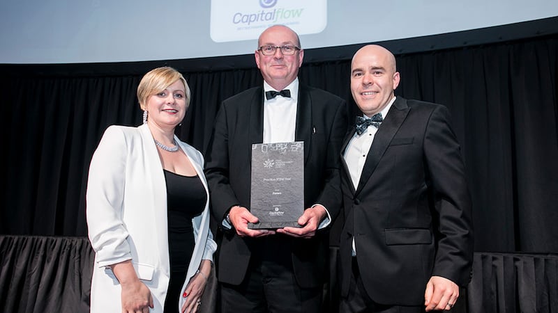 Colum Breslin, Managing Director, Capitalflow, presents the Practice of the Year award to Sinead Doherty & David O'Reilly, Fenero.