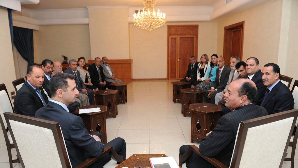 Syria’s president Bashar al-Assad (left) speaks with Shukri Bin Suleiman Harmasi (right), secretary general of the Tunisian al-Thawabit (Immutable Principles) Party, and head of a Tunisian delegation consisting of representatives of Tunisian political parties, and economic and popular movements, during a meeting in Damascus in this handout photograph distributed by Syria’s national news agency SANA yesterday.