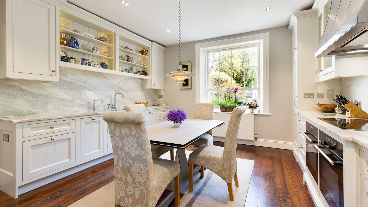 The kitchen, refurbished from a dark basement, is now a welcoming space with a huge window to let the morning sun pour in