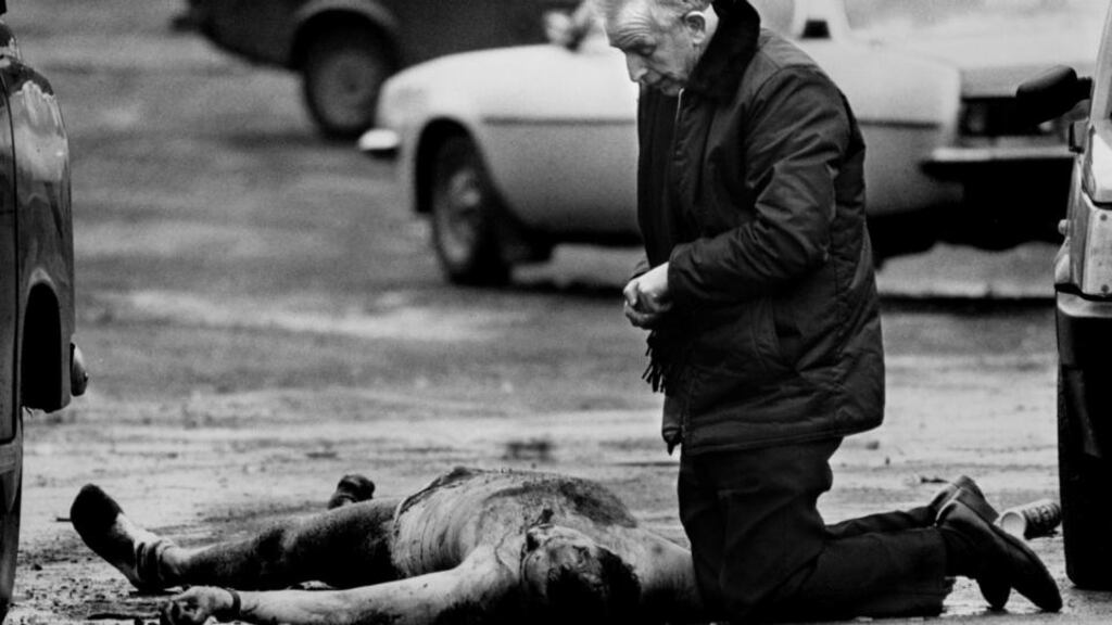 Fr Alec Reid administering the last rites
