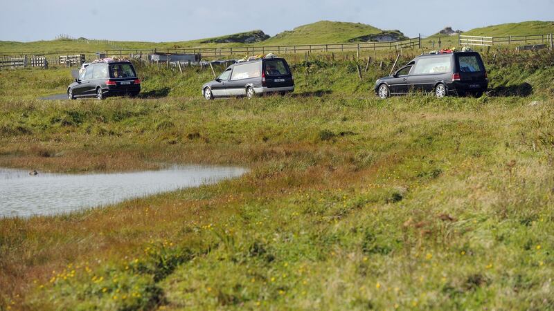 The three funeral hearses making their way to Cross Cemetery. Photograph: Conor McKeown