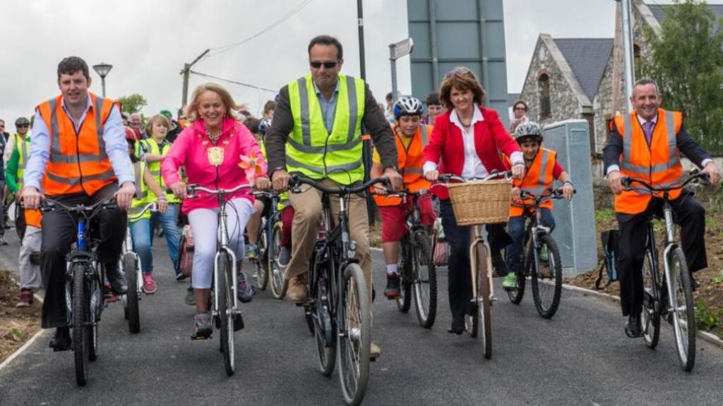 Leo Varadkar, backed up Joan Burton takes to his wheels on a new cycleway. Photograph: Brenda Fitzsimons