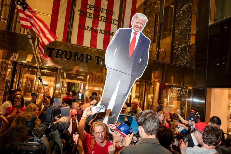 Trump supporters raise a cardboard cutout of their candidate outside Trump Tower in New York on Wednesday. Photograph: Karsten Moran/New York Times