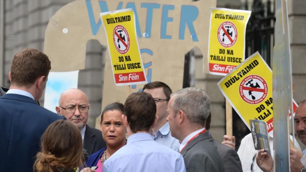 Sinn Féin TD Mary Lou McDonald speaks to reporters as party members protest against a water charges enforcement measure in the Environment Bill at Leinster House on Wednesday. Photograph: Dara Mac Dónaill/The Irish Times.