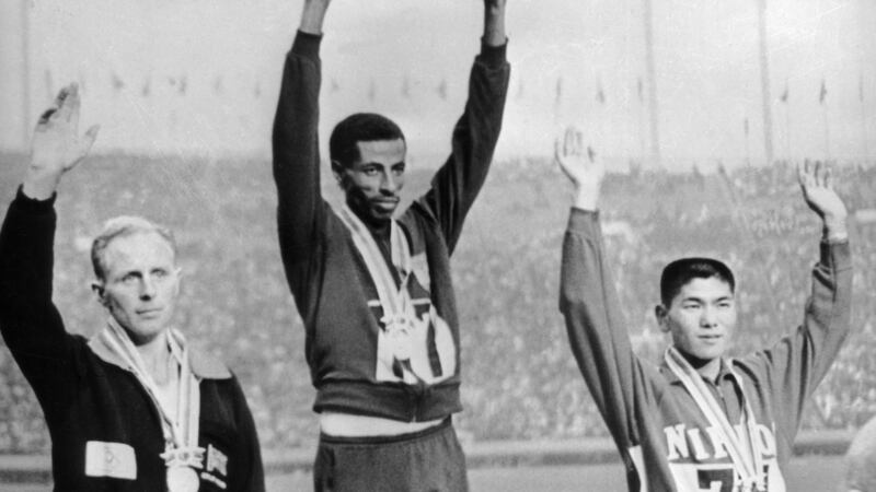 Basil Heatley of Great Britain (silver), Abebe Bikila of Ethiopia (gold) and Kokichi Tsuburaya of Japan (bronze) at the winners’ podium following the marathon event at the Tokyo Olympics in October 1964. Photograph: Keystone/Hulton Archive/Getty Images
