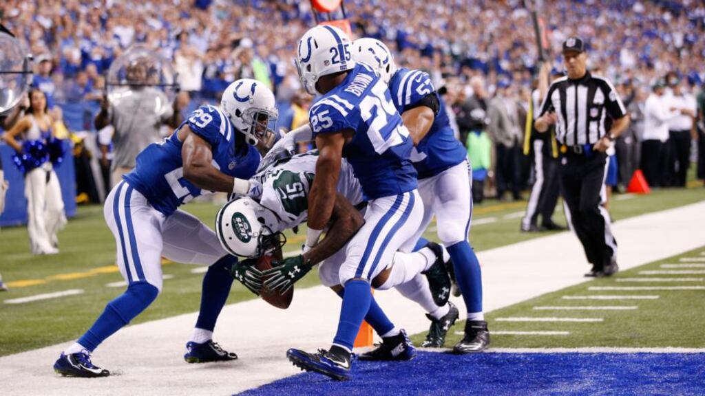 Brandon Marshall of the New York Jets carries three Indianapolis Colts defenders into the end zone for a 15-yard touchdown in the fourth quarter at Lucas Oil Stadium. Photograph: Joe Robbins/Getty Images