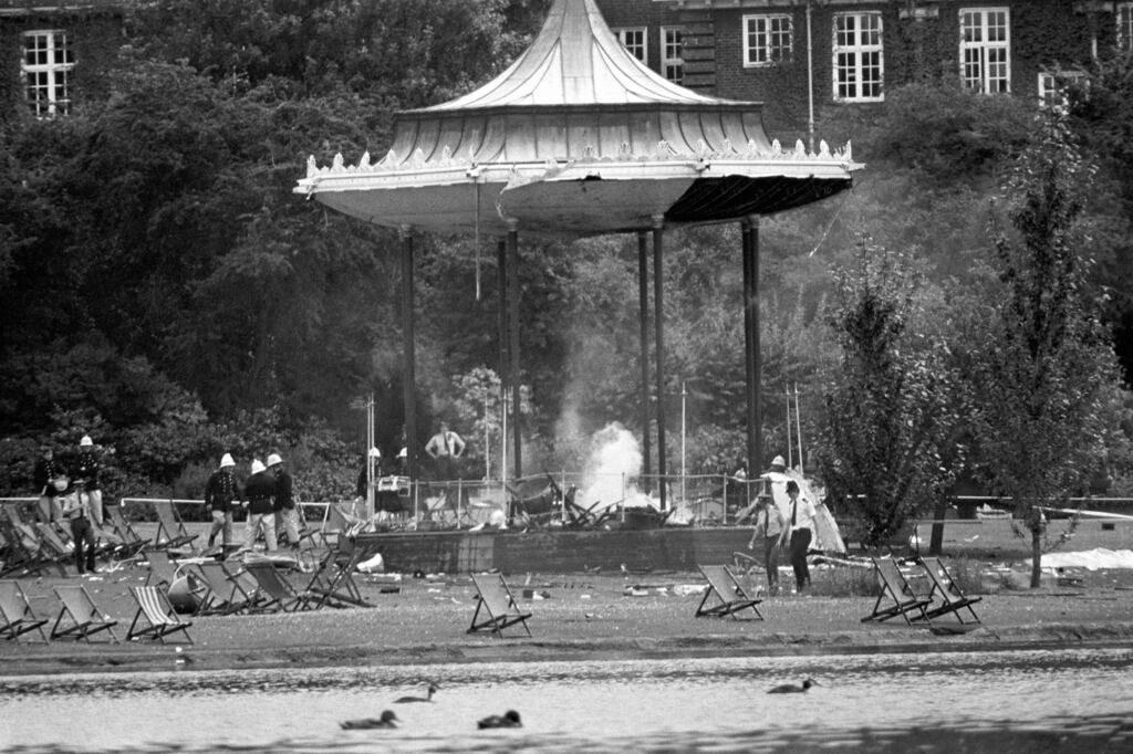 Police and firemen at the still-smouldering bandstand in Regents Park, London, following the IRA bomb blast that killed six people and left many others seriously injured.
