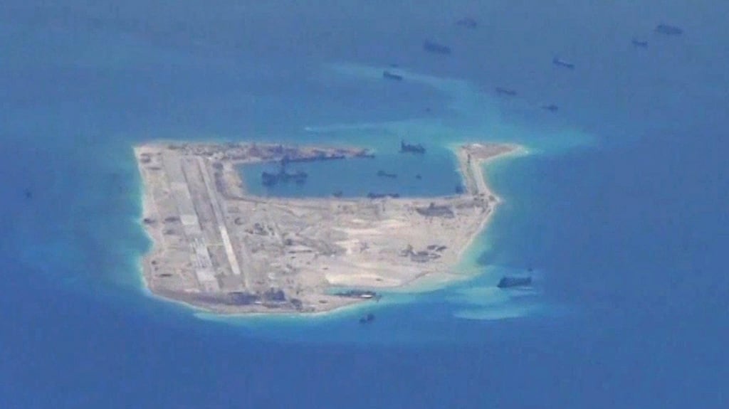 Chinese dredging vessels are purportedly seen in the waters around Fiery Cross Reef in the disputed Spratly Islands in the South China Sea in this still image from video taken by a P-8A Poseidon surveillance aircraft provided by the US Navy. Photograph: US Navy handout via Reuters.