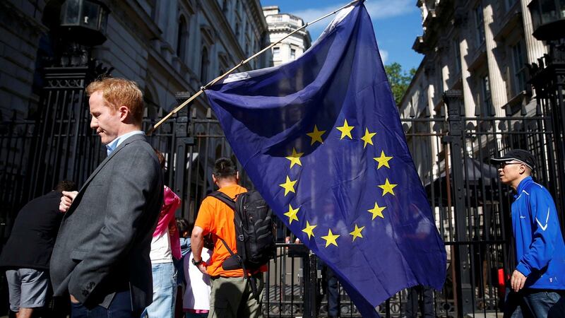 A man carries a EU flag outside Downing Street in London. Leading Irish businesses have voiced concern about Britain’s decision to leave the EU