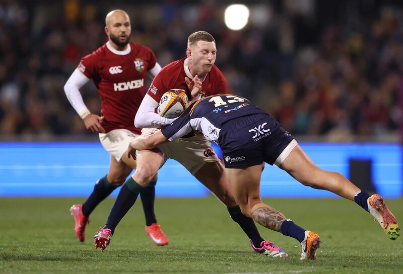 The Lions' Finn Russell is tackled by the Brumbies' Ollie Sapsford. Photograph: Mark Metcalfe/Getty Images