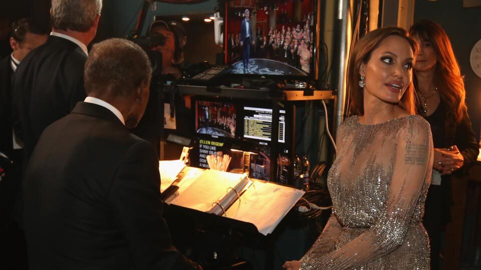 Behind the scenes: Angelina Jolie (and Sidney Poitier, on the stool) backstage in 2014. Photograph: Christopher Polk/Getty