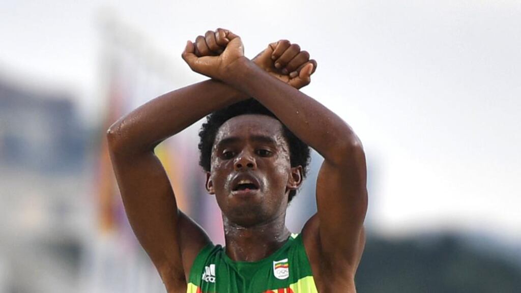 Feyisa Lilesa: the marathon runner’s gesture in Rio recalled the Black Power raised fists of Tommie Smith and John Carlos in Mexico in 1968. Photograph: Olivier Morin/AFP/Getty