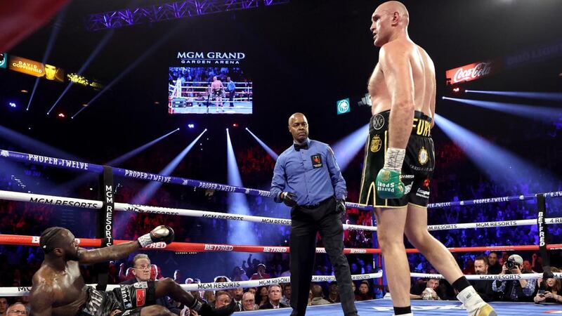 Tyson Fury knocks Deontay Wilder down in the third in Las Vegas. Photograph: Al Bello/Getty