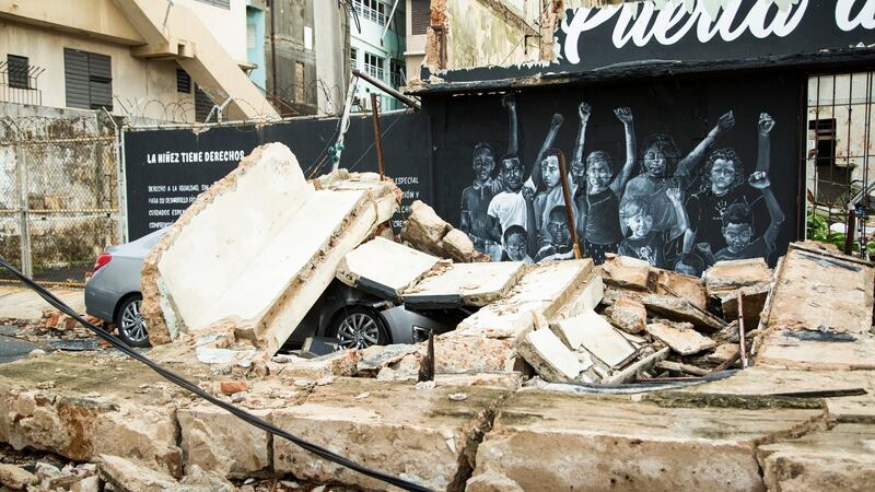 A car is crushed under the rubble of a collapsed building after Hurricane Maria in the Puerta de Tierra area of San Juan, Puerto Rico, on Thursday. Photograph: Erika P Rodriguez/NYT