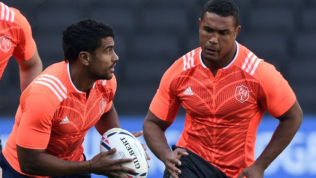 Wesley Fofana runs with a ball next to captain Thierry Dusautoir during a France training session at Stadium MK in Milton Keynes. Photograph: Getty