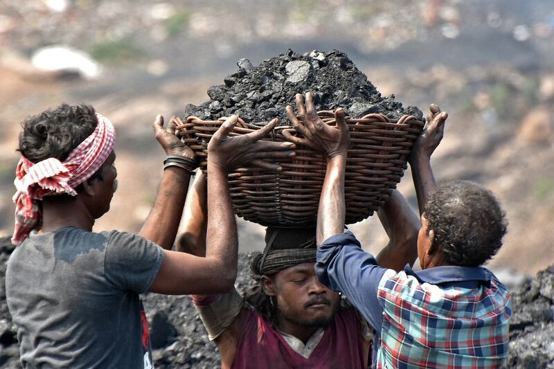 Workers prepare to load coal onto a truck at the Jharia coalfield. Photograph: Gautam Dey/AFP/Getty Images